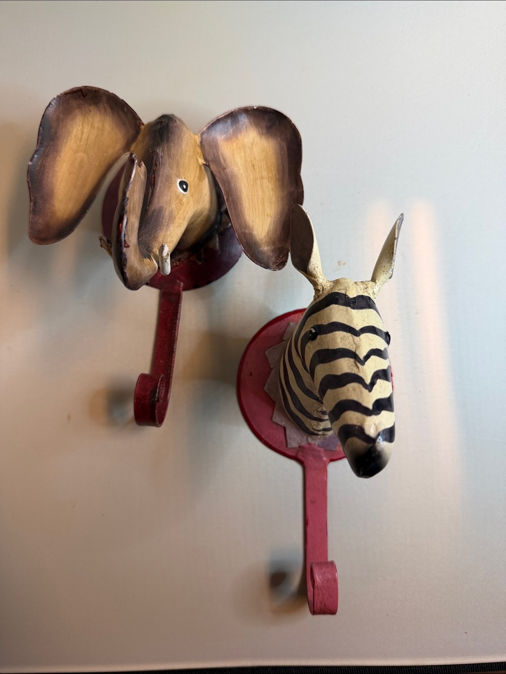 Adorable metalwork zebra and elephant wall hooks made in India